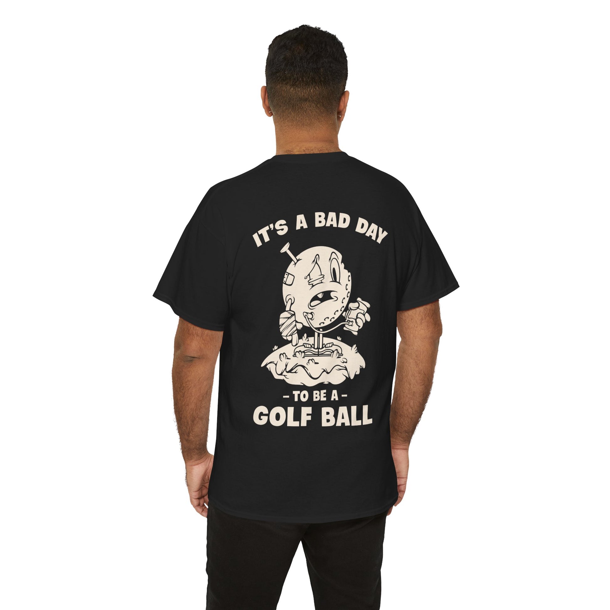 Vintage cartoon design of a beat-up golf ball with a cast, swollen eye, IV bag, and a golf tee stuck in its head, standing on a tee with the text ‘It’s a Bad Day to Be a Golf Ball.