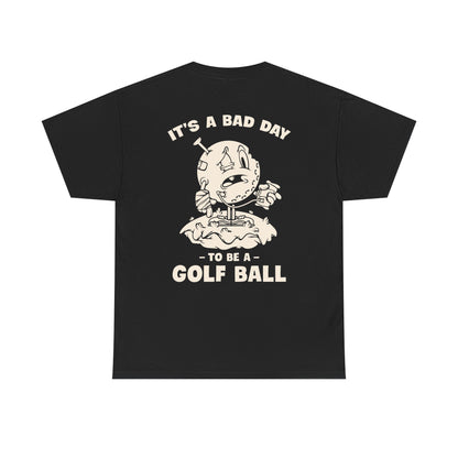 Vintage cartoon design of a beat-up golf ball with a cast, swollen eye, IV bag, and a golf tee stuck in its head, standing on a tee with the text ‘It’s a Bad Day to Be a Golf Ball.