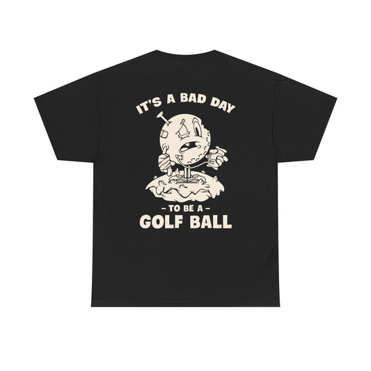 Vintage cartoon design of a beat-up golf ball with a cast, swollen eye, IV bag, and a golf tee stuck in its head, standing on a tee with the text ‘It’s a Bad Day to Be a Golf Ball.